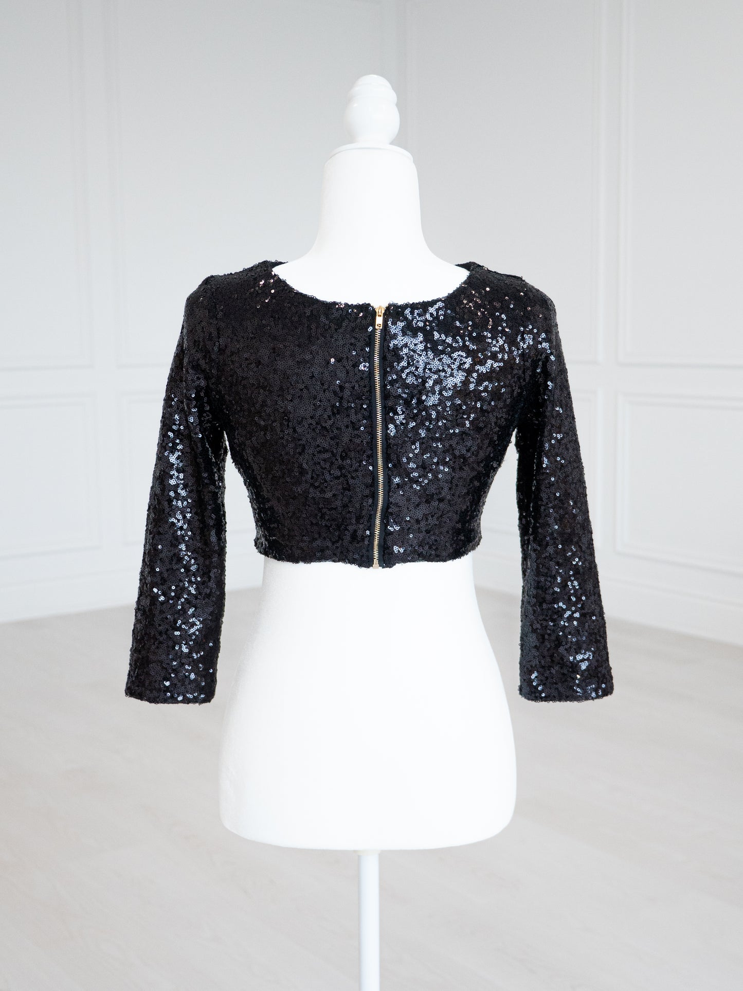 Black Sequin Blouse with a scoop neckline, sleeveless design and stretch lining for a close fit. Fully finished and ready to wear with sarees, lehengas or skirts.