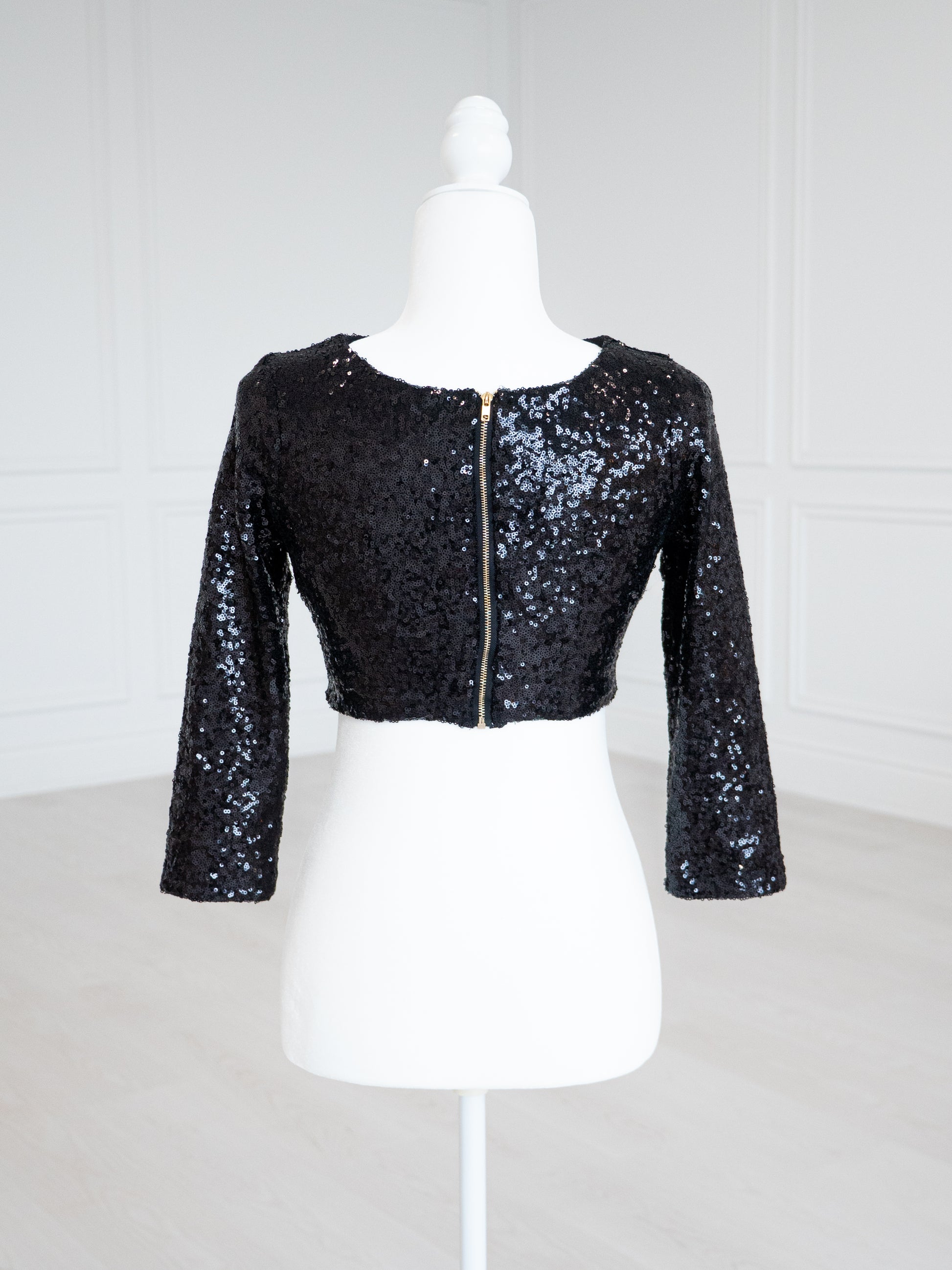 Black Sequin Blouse with a scoop neckline, sleeveless design and stretch lining for a close fit. Fully finished and ready to wear with sarees, lehengas or skirts.