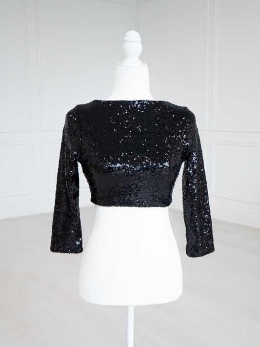 Black Sequin Blouse with a scoop neckline, sleeveless design and stretch lining for a close fit. Fully finished and ready to wear with sarees, lehengas or skirts.