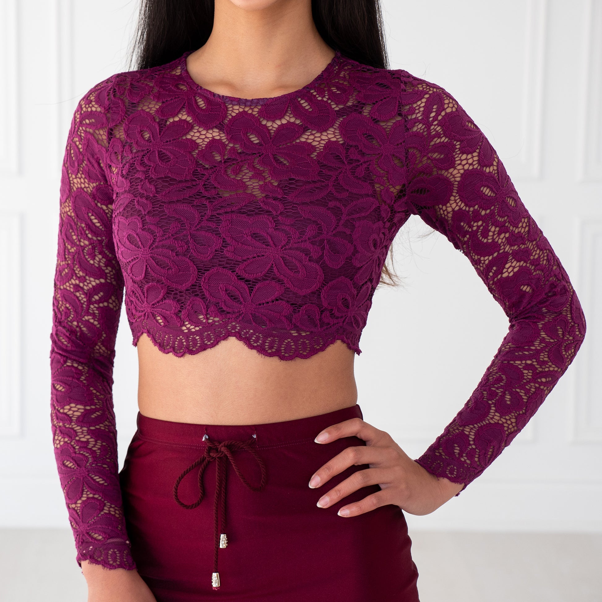 Plum Lace Crop Top with floral pattern, scalloped edges and sheer sleeves, designed to pair with sarees or lehengas. Readymade, fully lined body with reversible neckline.